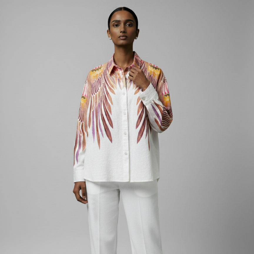 Person wearing a patterned shirt and white pants on a gray background