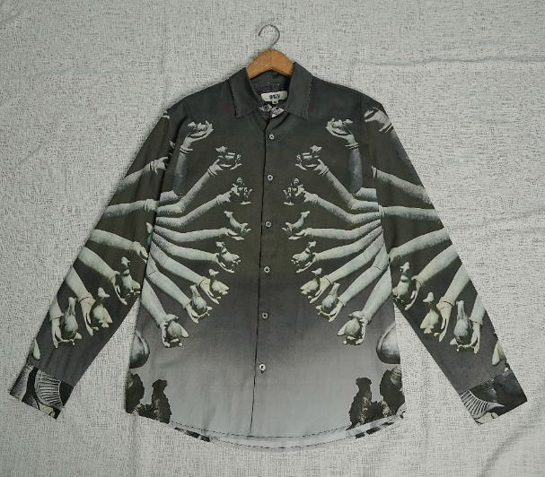 Black and white patterned shirt on a hanger against a light gray background