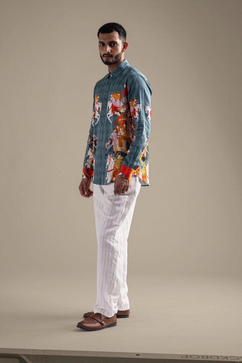 Man wearing the Kirtharjuna shirt, full length side view, looking over his shoulder