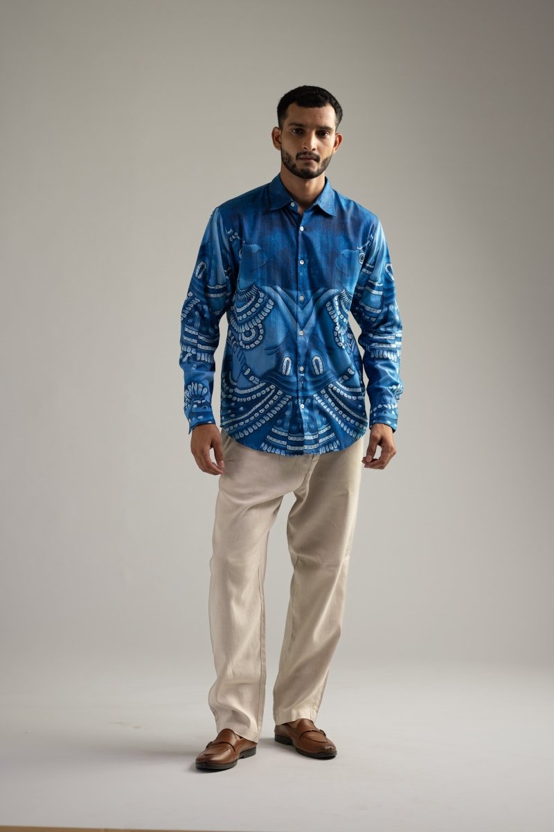 Man wearing the Vanaryugalam shirt with cream trousers, full length front view, hands at his sides